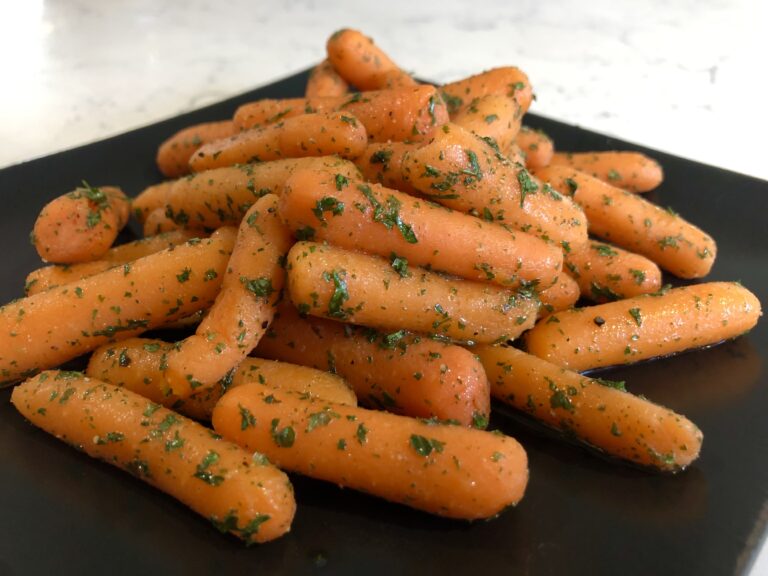 A close up image of honey glazed carrots.