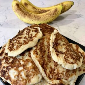 A close up image of banana pancakes that were created using this recipe