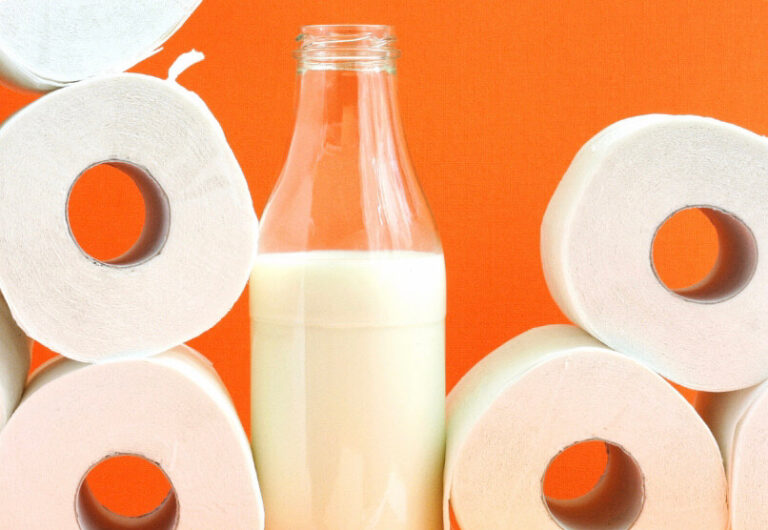 an up close image of a bottle of milk with toilet paper