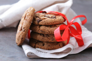 A close up image of anti-inflammatory gingerbread cookies tied in a red ribbon.